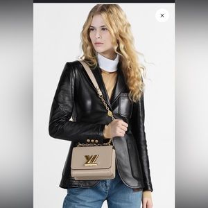 Made from Epi leather and accented with the gleaming gold-color LV Twist lock,